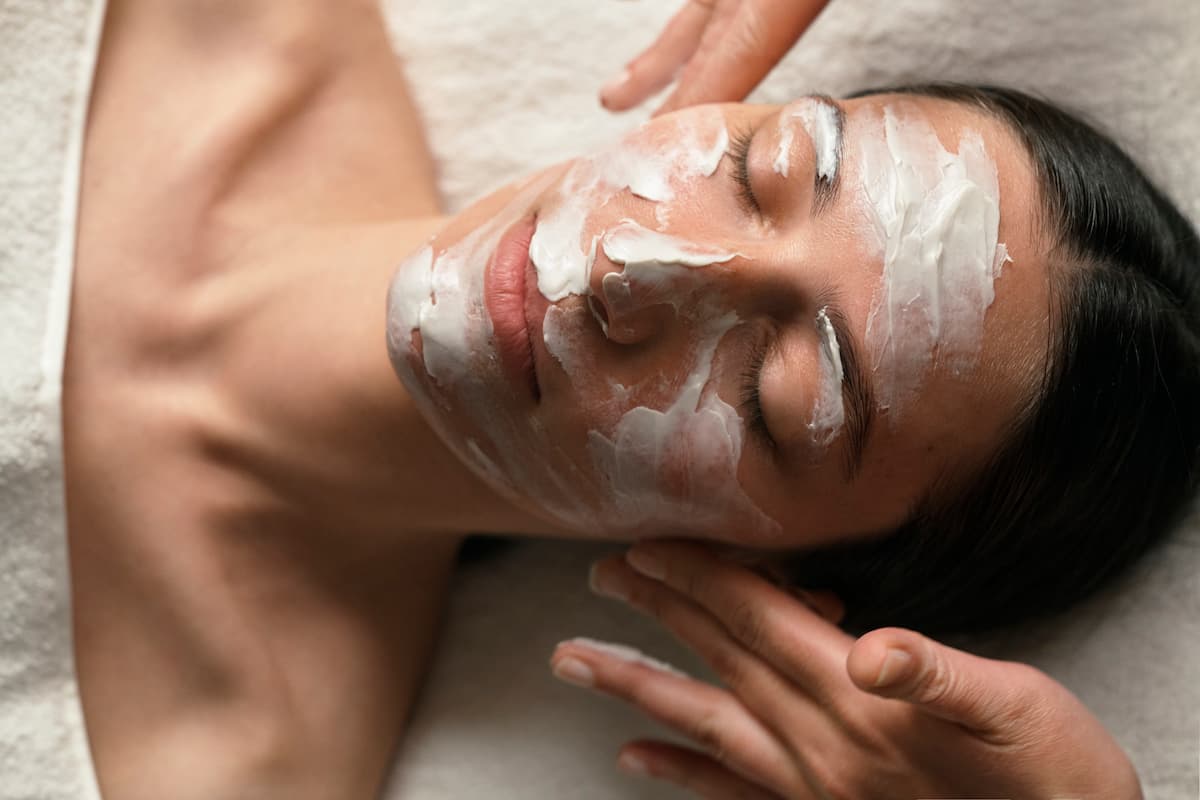 Aplicación de mascarilla reafirmante durante sesión de tratamiento facial con cosmética Dr. Hauschka en Sitges